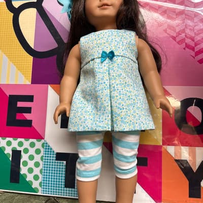 Brunette Doll In Blue Floral Tunic And Striped Leggings
